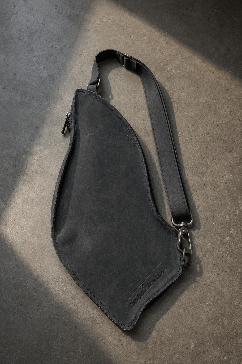Hígado Bag back view in black leather with stamped Imminent Occurrence logotype