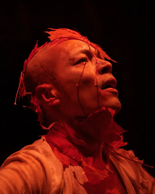 Valentin Tszin in red-lit Butoh performance