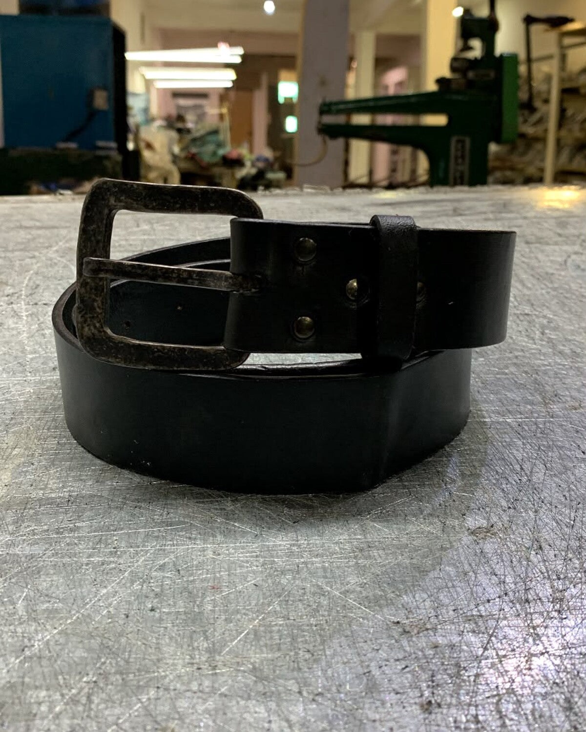Aevum leather belt photographed in the León workshop