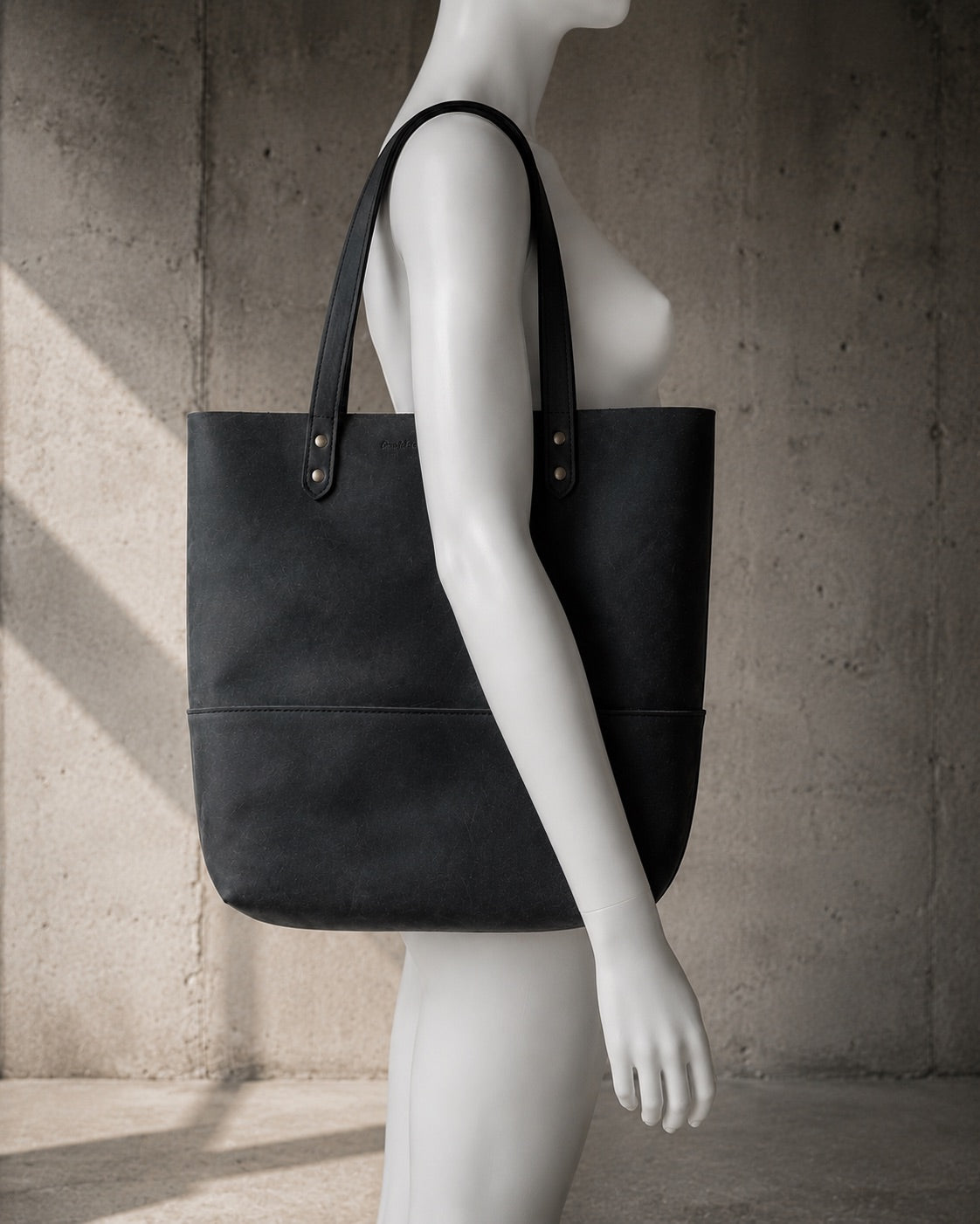 Imminent Occurrence leather tote bag shown on mannequin for scale