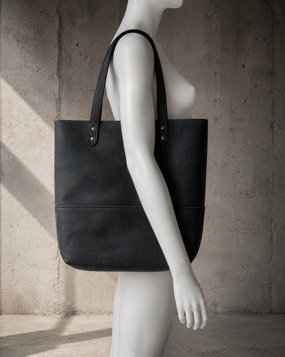 Imminent Occurrence leather tote bag shown on mannequin for scale