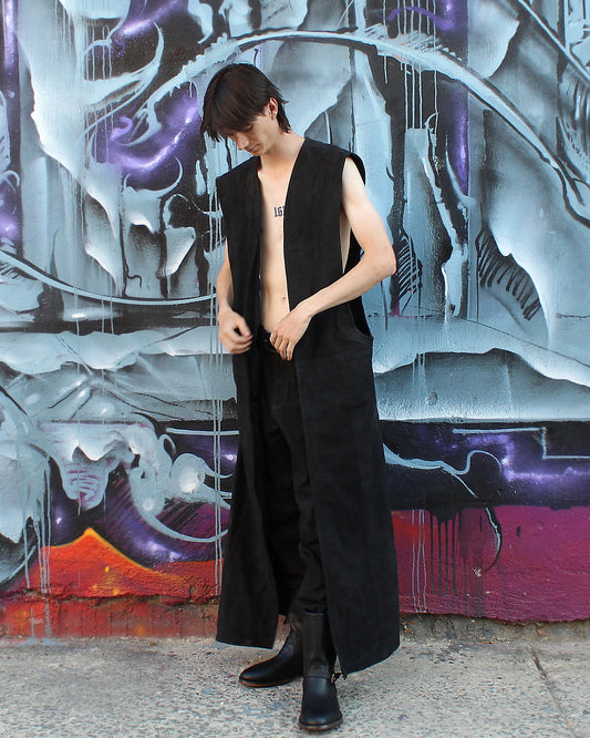 Model wearing the Imminent Occurrence ankle-length sleeveless leather duster